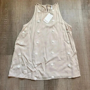 NWT, never worn cream tank with white Pom detail. Size Small